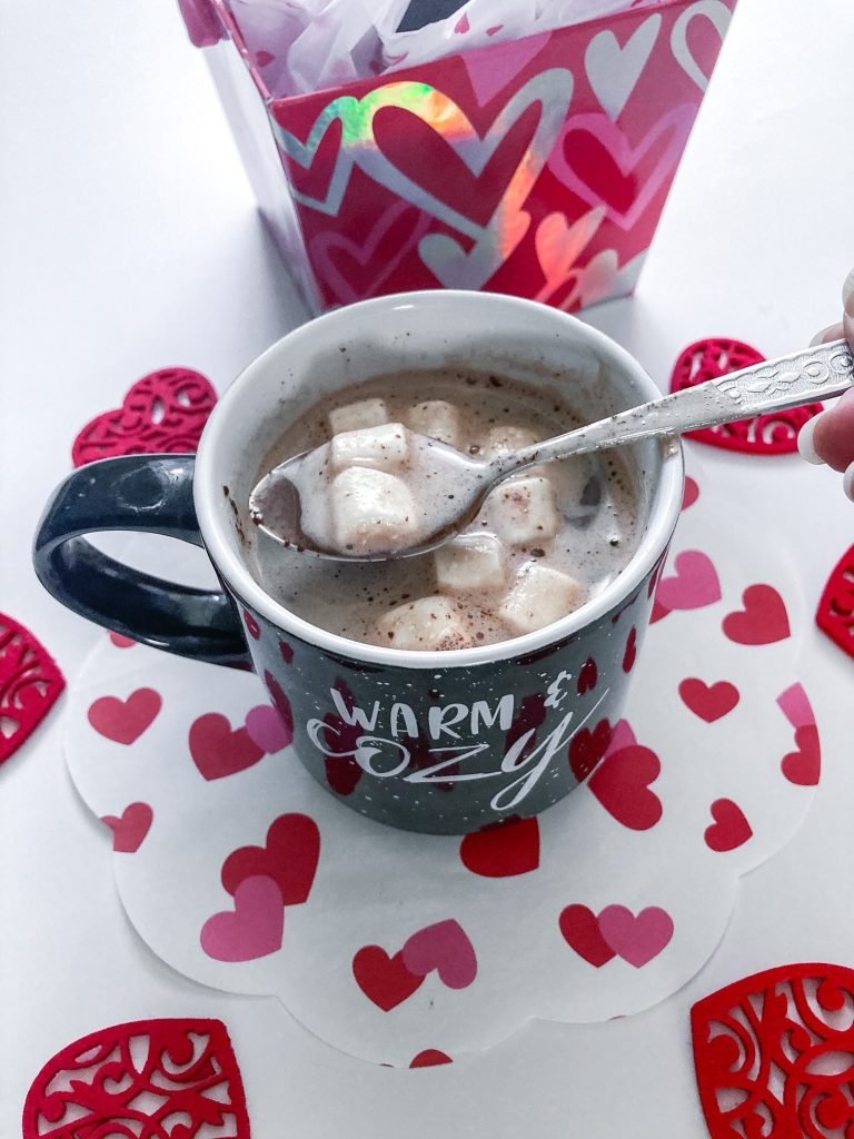 Hot cup of milk with chocolate bomb with marshmallows